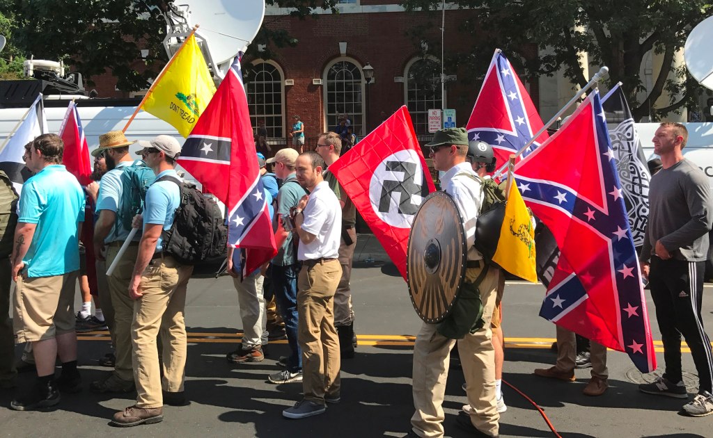 Rally participants carrying Nazi, Confederate and Gadsden flags near Emancipation Park, Charlottesville, August 12, 2017.